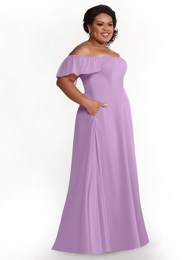 A woman wears Avery Austin's 80168: a chiffon, off-the-shoulder, floor-length lavender A-line dress with pockets and ruffled short sleeves, standing against a white background.