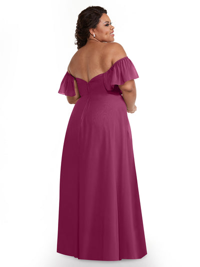 A woman models Avery Austin dress 80168, a floor-length magenta chiffon A-line with off-the-shoulder short ruffled sleeves, shown from the back against a white background.