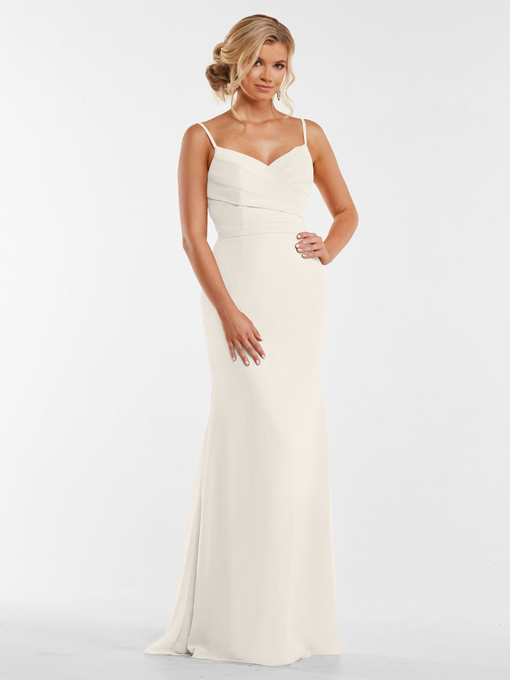 A woman stands against a plain white background wearing the Avery Austin 80169: a sleeveless, floor-length white chiffon dress with thin straps and a fitted pleated bodice. Her hair is styled in loose curls.