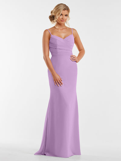 A woman with blonde hair in an elegant updo, hands gently clasped, models Avery Austin style 80169—a long light purple chiffon dress with a pleated bodice—against a plain white background.