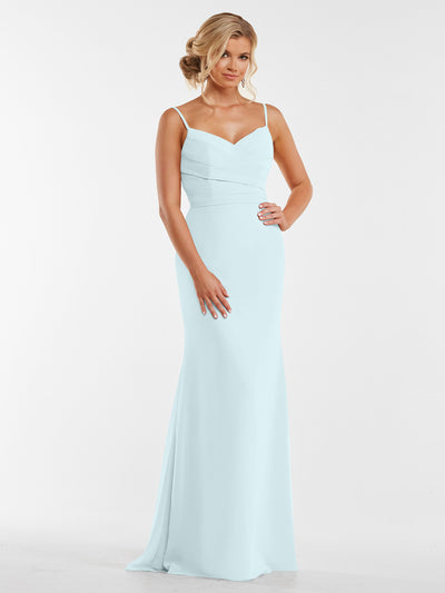 A woman stands against a plain white background wearing Avery Austin style 80169, a light blue, floor-length chiffon dress with thin straps and a fitted, pleated bodice.
