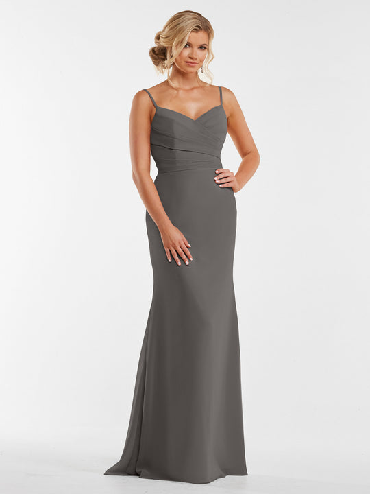 A woman with blonde hair in an elegant updo models Avery Austin's floor-length chiffon dress 80169, featuring a slate gray hue, thin straps, and a fitted pleated bodice, against a plain white background.