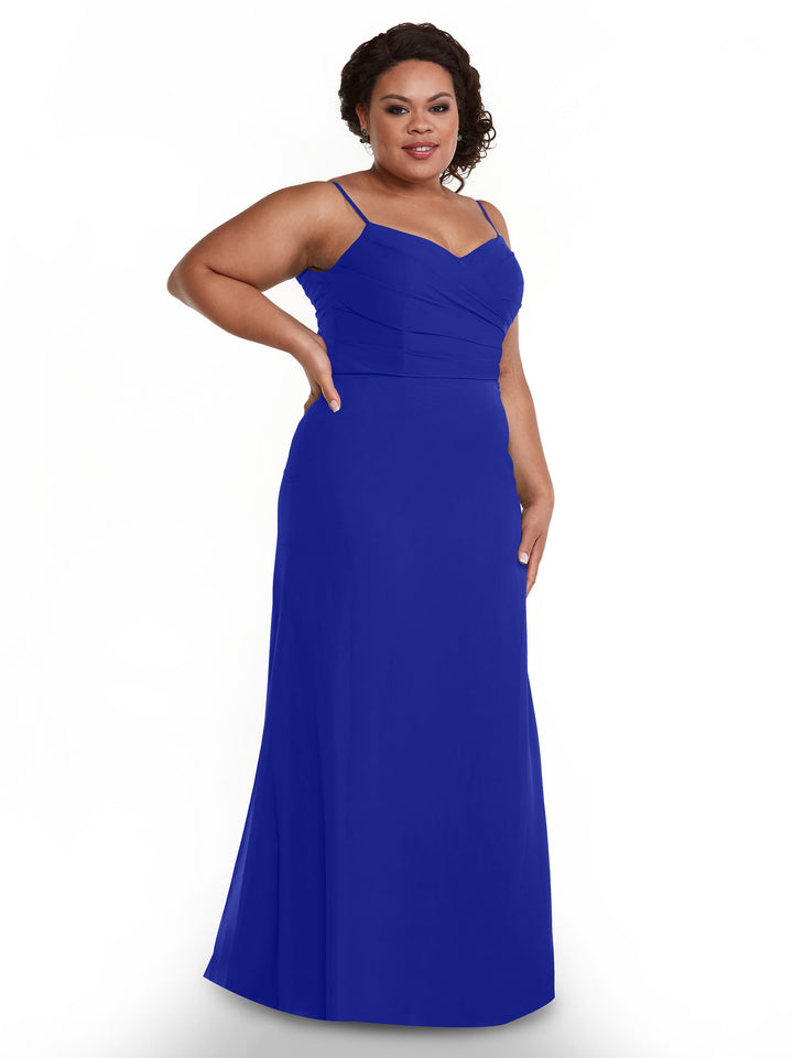 A woman in Avery Austin’s 80169: a sleeveless, floor-length cobalt chiffon dress with thin straps and a fitted pleated bodice, stands against a plain white background.