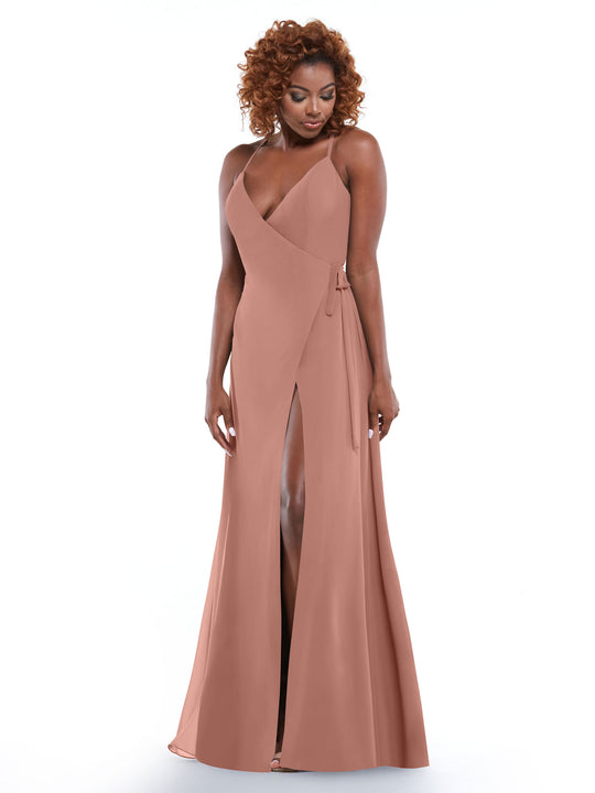 A woman with curly hair wears Avery Austin’s 80171, a rose sheath dress with a deep V-neck, high front slit, and self-tie sash, standing against a white background.