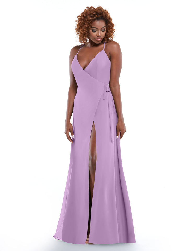 A woman models the Avery Austin 80171 dress—a sleeveless lavender gown with thin straps, a self-tie sash, and a high front slit—standing against a plain white background and smiling downward.
