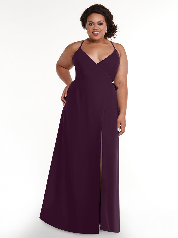 A woman stands and smiles against a plain white background wearing Avery Austin&