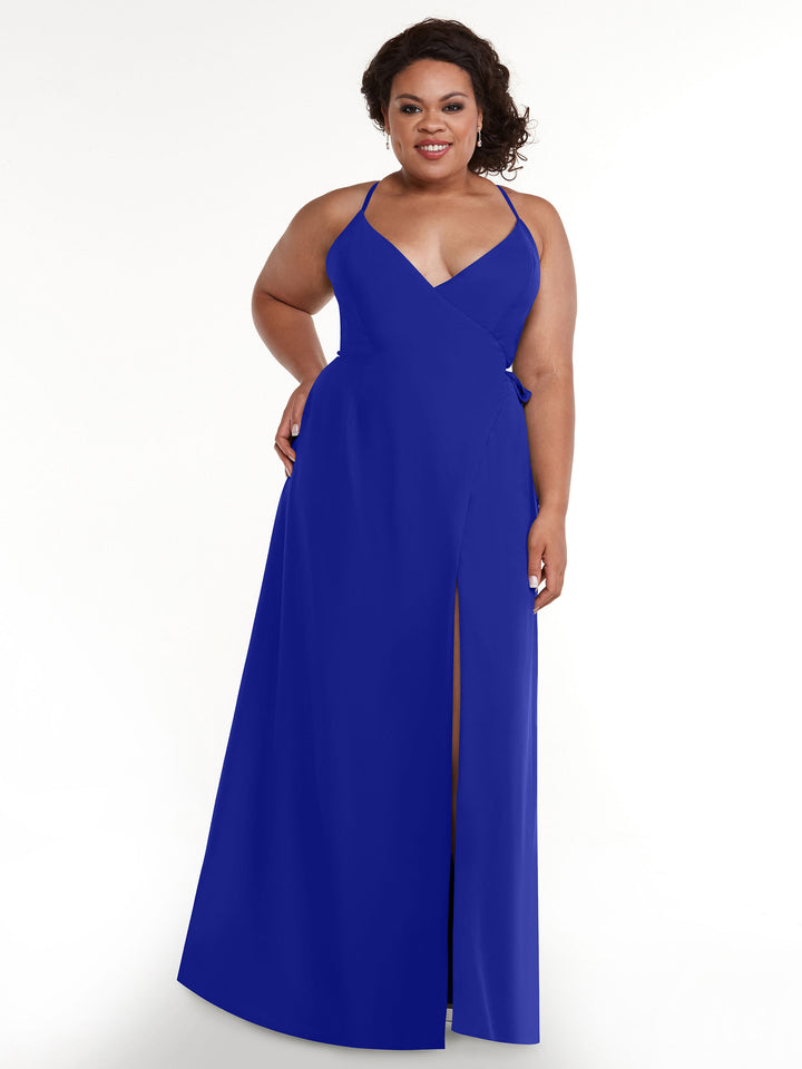 A woman models Avery Austin’s 80171: a sleeveless royal blue slit dress with V-neckline and self-tie sash, smiling against a plain white background.