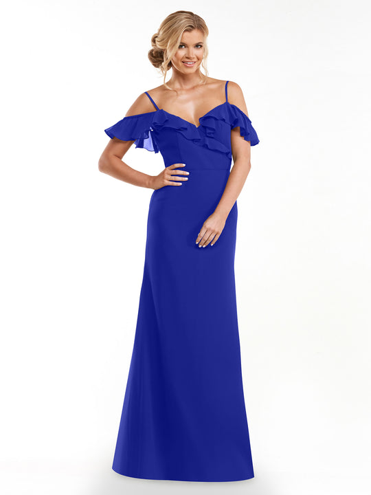 A woman with blonde hair in an updo models the Avery Austin 80172 royal blue A-line dress, featuring off-the-shoulder sleeves and a ruffled neckline, against a plain white background.
