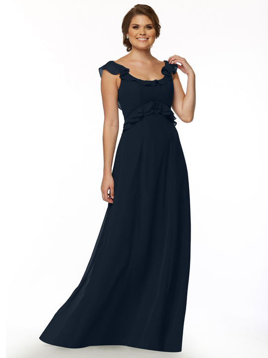 A woman smiles while wearing Avery Austin's 80173— a dark navy, floor-length gown with a ruffled neckline and fitted waist—posing against a plain white background.