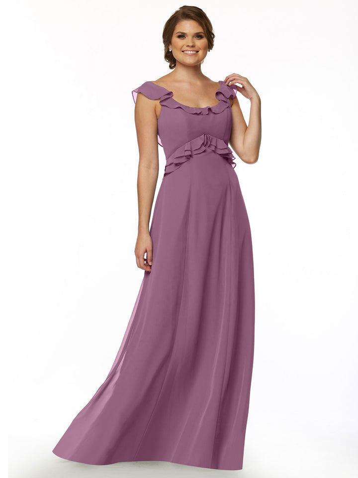 A woman stands smiling against a plain white background, wearing Avery Austin’s 80173: a long, sleeveless mauve dress with ruffled details at the neckline, shoulders, and waist.