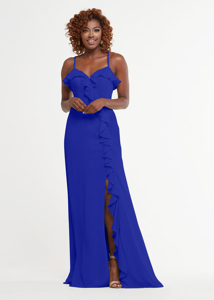 A woman in the Avery Austin 80174 royal blue A-line gown with spaghetti straps, a ruffled skirt, and a sweetheart bodice smiles against a plain white background.