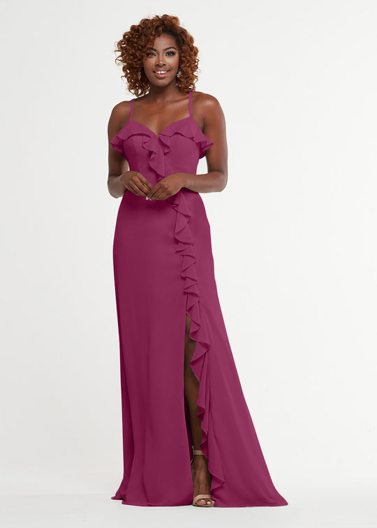 A woman models Avery Austin's 80174: a floor-length, sleeveless magenta dress with thin straps, a sweetheart bodice, ruffle details along the neckline, and a ruffled side slit, standing against a plain white background.