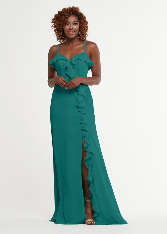A woman with curly hair wears Avery Austin style 80174, a sleeveless teal dress with a sweetheart bodice, ruffled neckline, diagonal skirt ruffle, and thigh-high slit. She stands smiling against a plain white background.