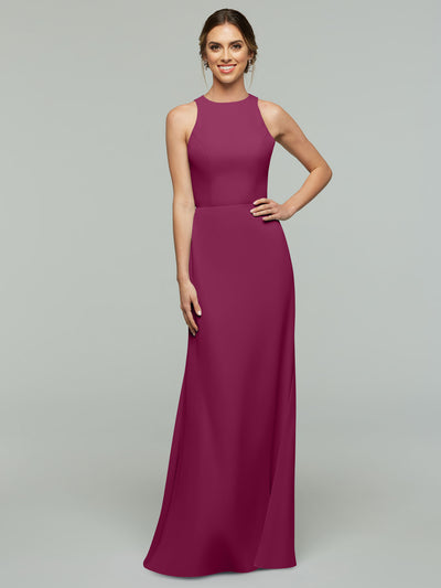 A woman stands smiling in Avery Austin’s 80175, a magenta sleeveless A-line dress with a fitted bodice, straight skirt, and keyhole back. Her hair is tied back, one hand on her hip, against a plain light gray background.