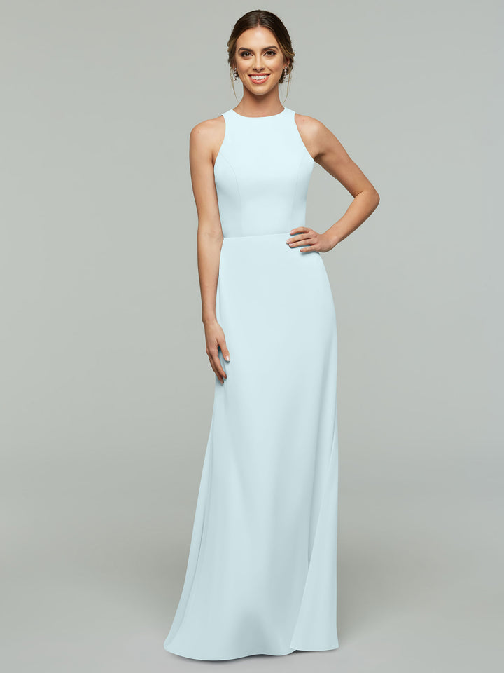 A woman poses against a plain background in the Avery Austin 80175, a light blue, sleeveless A-Line dress with a high neckline. She smiles confidently with one hand on her hip and her hair styled back.