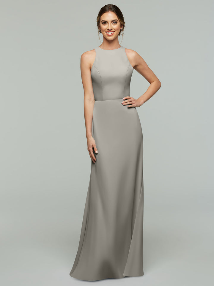 A woman smiles in the Avery Austin 80175, a long, sleeveless, light grey A-line dress with a high neckline and fitted bodice, posed against a plain light grey background.
