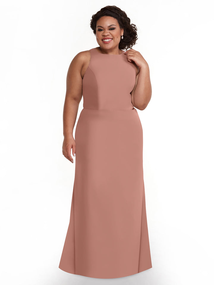 A woman with curly dark hair wears the Avery Austin 80175, a sleeveless, floor-length blush pink A-line V-neck dress, and smiles against a plain white background.