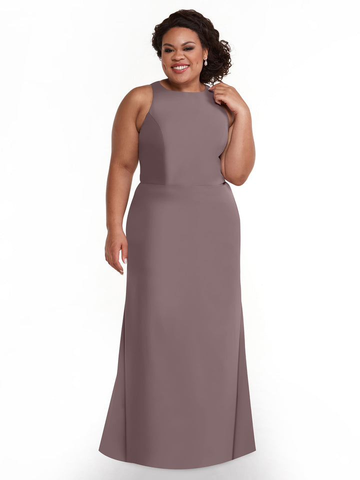 A woman with curly hair models the Avery Austin 80175 long, sleeveless mauve A-line dress, smiling with one hand in her hair against a plain white background.