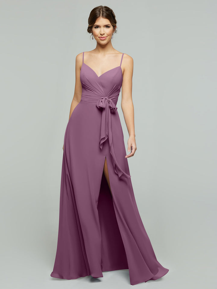 A woman models the averyaustin 80182: a long, dusty rose chiffon dress featuring spaghetti straps, a V-neckline, tie waist, and thigh-high slit.