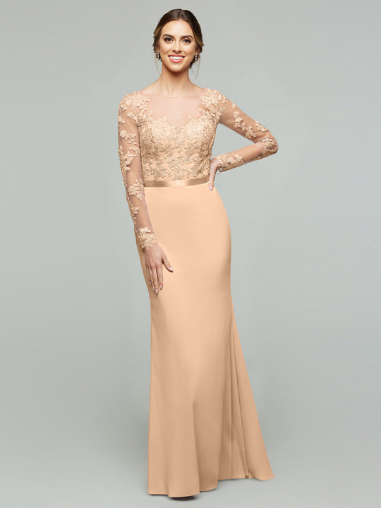 A woman smiles against a plain gray background, wearing the averyaustin 80190 peach chiffon mermaid dress with a lace bodice and illusion lace sleeves.