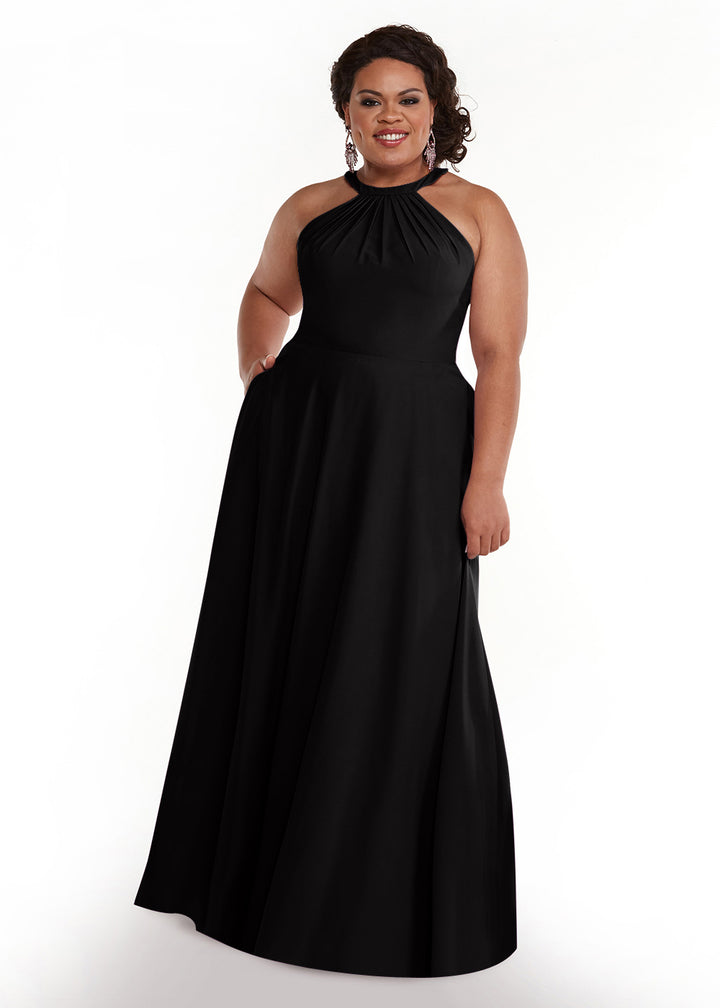 A woman smiles against a plain white background, wearing Avery Austin&