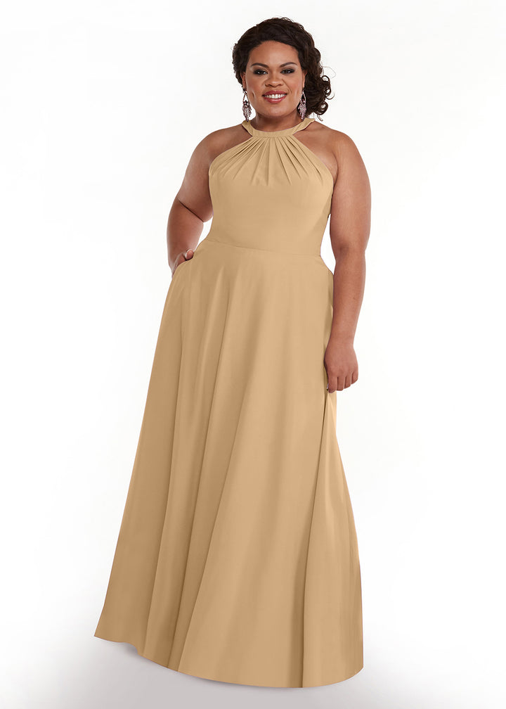 A woman with curly dark hair, wearing earrings, stands smiling with one hand in her pocket. She models Avery Austin&