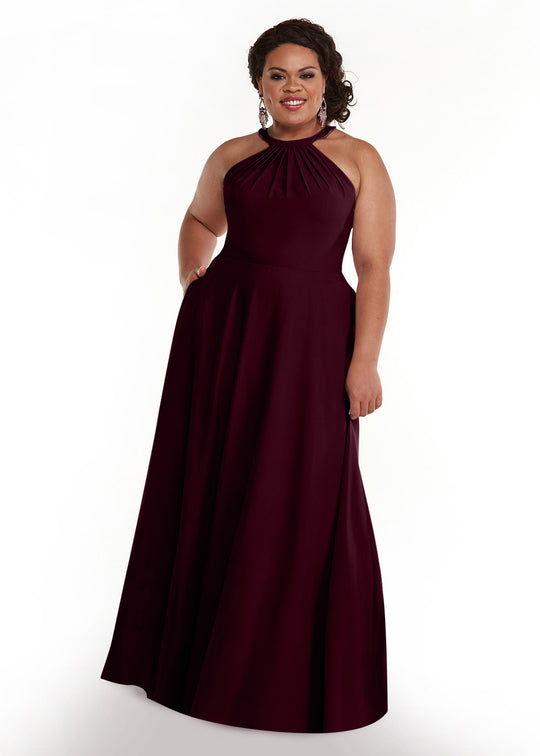 A woman in the Avery Austin TH-83002 sleeveless, floor-length, dark burgundy A-line halter dress smiles against a plain white background.