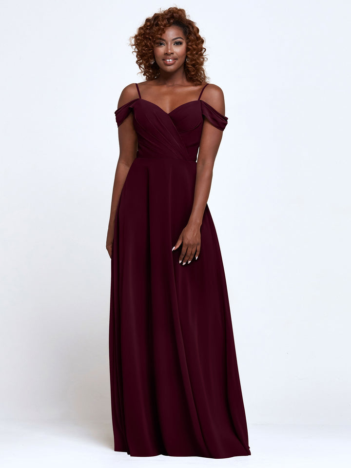 A woman with curly hair smiles while wearing Avery Austin&