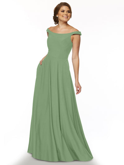 A woman smiles against a white background wearing Avery Austin’s 83005, an elegant sage green off-the-shoulder dress with a fitted bodice and flowing floor-length skirt.