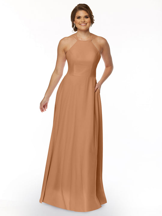 A woman poses against a plain white background wearing the Avery Austin 83006: a sleeveless, floor-length A-line dress with a halter neckline, fitted bodice, and flowing skirt for an elegant look.
