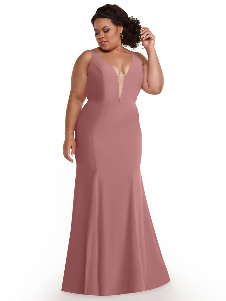 An elegant woman in the Avery Austin TH-83010 mermaid dress in dusty rose with a plunging neckline.