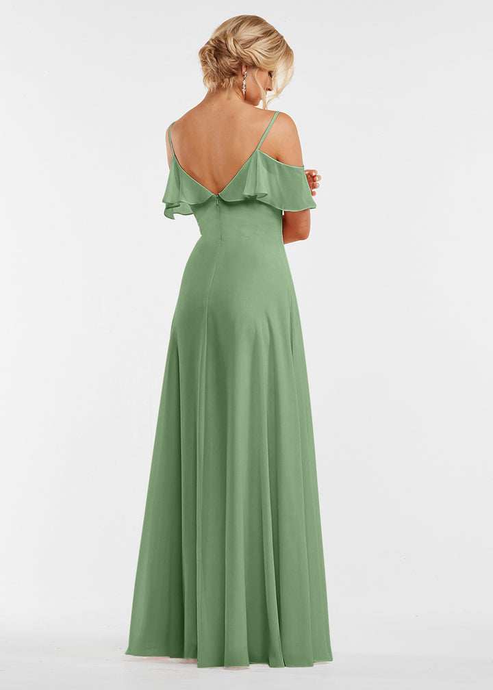 A woman poses with her back to the camera, showcasing Avery Austin’s 83013—a floor-length sage green dress with spaghetti straps and a ruffled neckline. Her elegant updo highlights the dress’s delicate details.