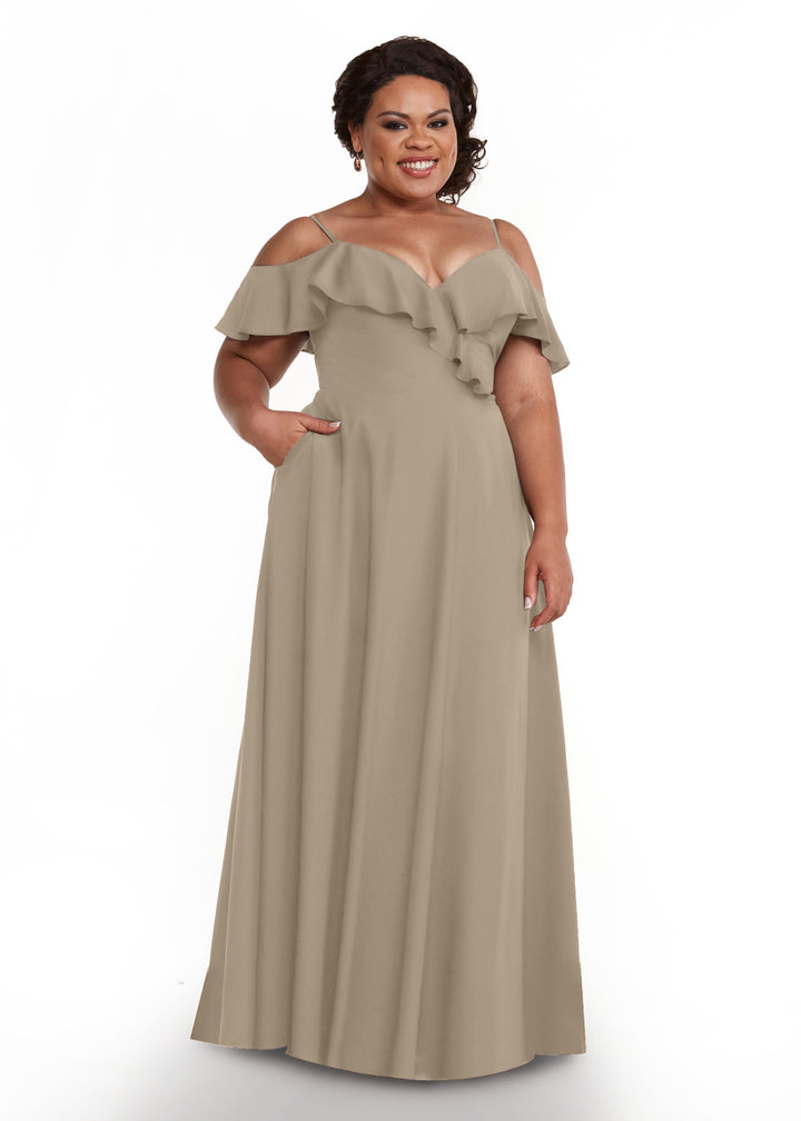 A woman smiles in front of a plain white background, modeling Avery Austin&