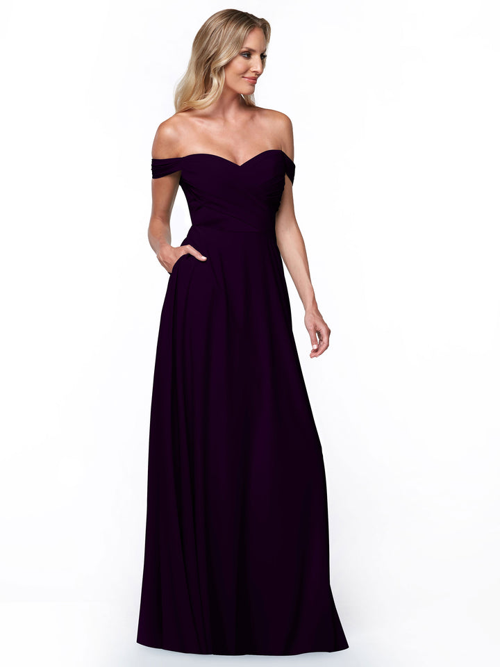 A woman with long, wavy blonde hair wears Avery Austin&