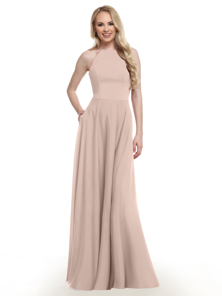 A woman with long blonde hair wears Avery Austin’s 83022 sleeveless, floor-length rose pink gown with a fitted bodice and elegant A-line skirt, standing and smiling against a white background.