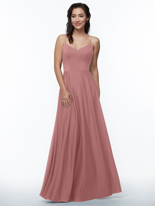 A woman smiles in an Avery Austin 83024 dress, featuring double spaghetti straps and a rose-colored A-line silhouette with a fitted bodice and flowing skirt, set against a plain white background.