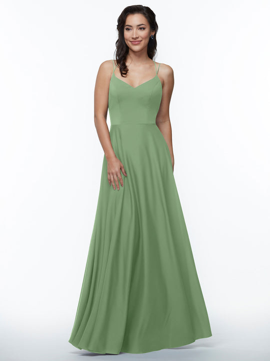 A woman models the Avery Austin 83024, an elegant long sage green A-line dress with double spaghetti straps, against a plain white background, smiling with one hand by her side and the other touching her dress.