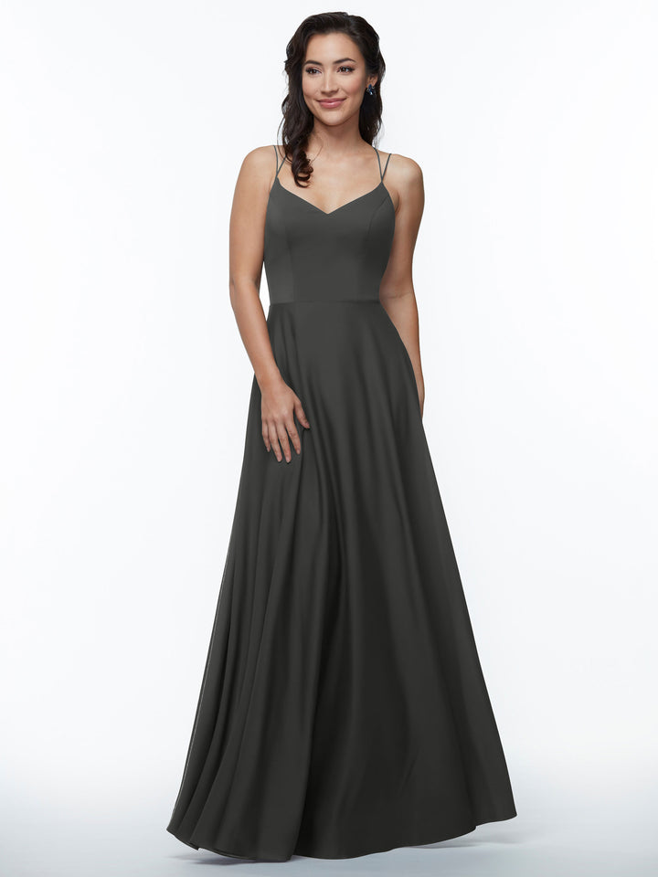 A woman with wavy dark hair smiles gently while wearing Avery Austin&