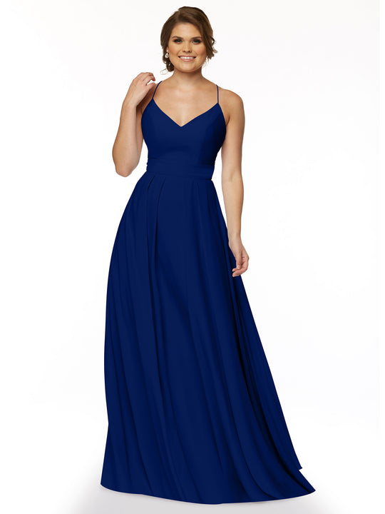 A woman smiles while wearing Avery Austin’s 83027, a sleeveless, floor-length deep blue A-line dress with spaghetti straps and a fitted bodice, against a plain white background.