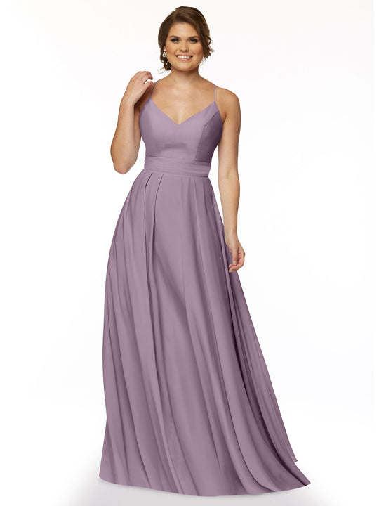 A woman wearing Avery Austin’s 83027: a floor-length, A-Line lavender gown with spaghetti straps, fitted bodice, V-neckline, and flowing skirt stands smiling against a plain white background.