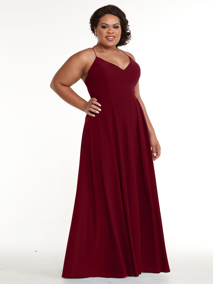 A woman stands confidently with one hand on her hip, modeling Avery Austin&