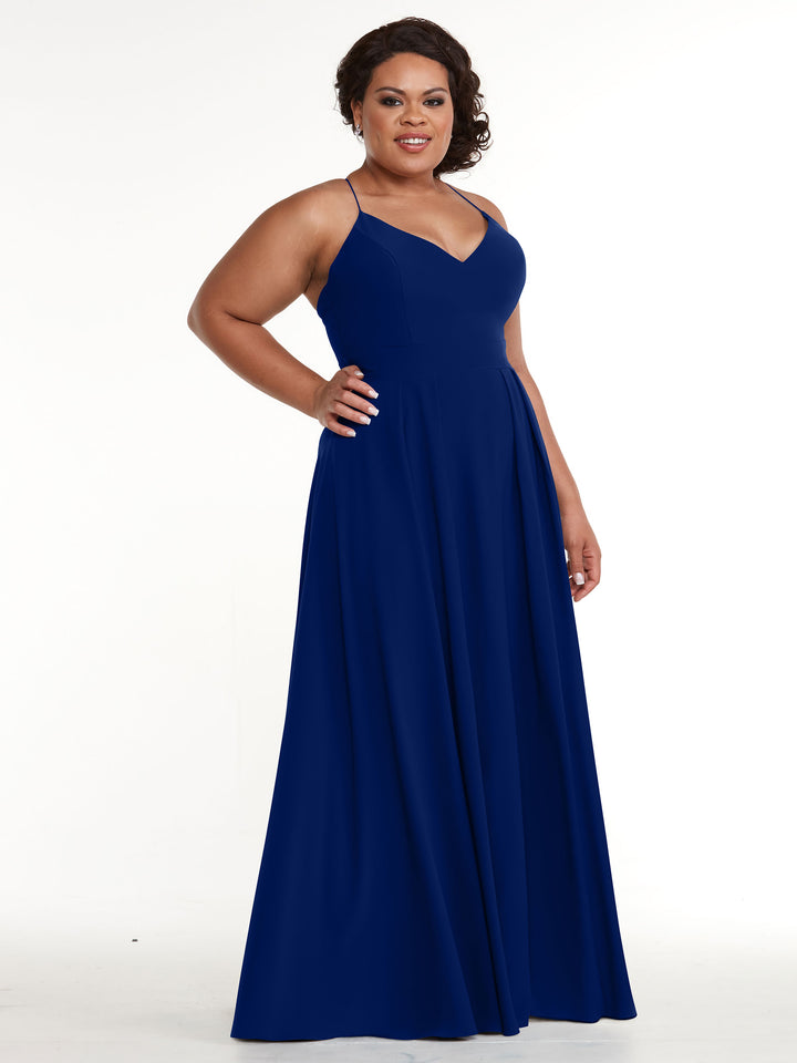A woman poses confidently with her hand on her hip, wearing Avery Austin&