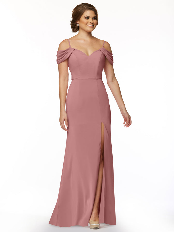 A woman models the Avery Austin TH-83029: a floor-length mauve-pink fitted dress with off-the-shoulder draped sleeves, sweetheart neckline, and high front slit, posing against a plain white background.