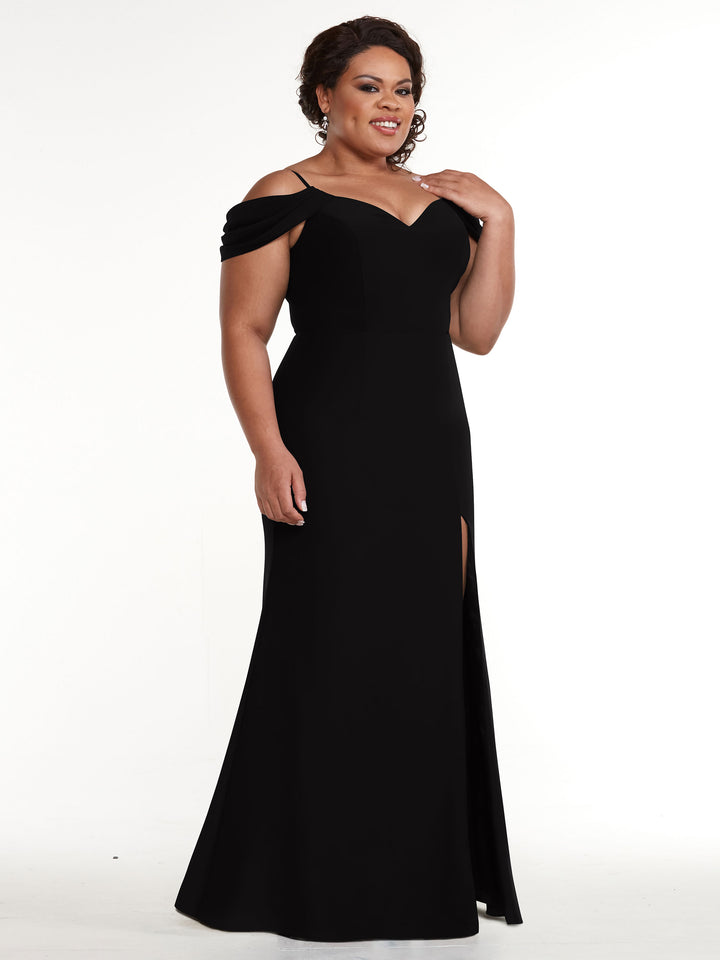 A woman wearing the Avery Austin TH-83029, a fitted, floor-length off-the-shoulder dress with a sweetheart neckline and thigh-high slit, stands smiling against a white background.