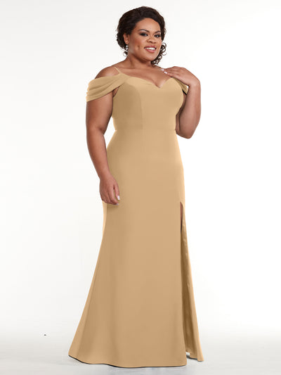 A woman wears Avery Austin style 83029, a floor-length, off-the-shoulder fitted dress with a sweetheart neckline and thigh-high slit, smiling against a white background.