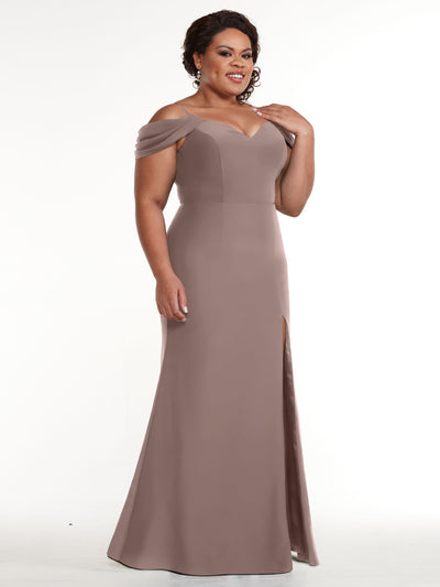 A woman smiles gently against a plain white background, wearing the Avery Austin 83029 mauve off-the-shoulder dress with a sweetheart neckline and slit.