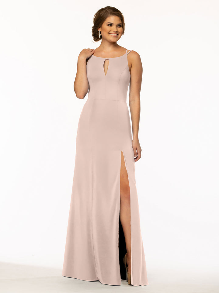 A woman wearing Avery Austin style 83030, a sleeveless rose pink sheath dress featuring a keyhole neckline and a high side slit, poses against a plain white background.