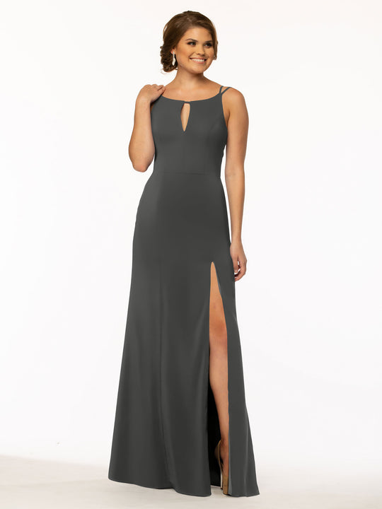 A woman models Avery Austin’s 83030, a sleeveless, floor-length dark gray sheath dress with a keyhole neckline and high slit, standing against a plain white background.