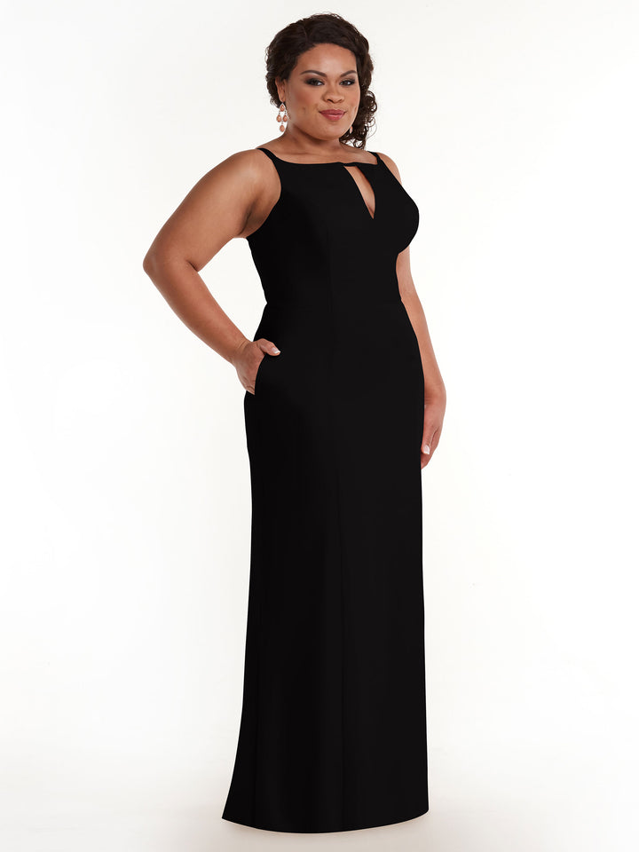A woman stands confidently against a plain white background wearing Avery Austin 83030, a long sleeveless black sheath dress featuring a keyhole neckline and side pockets.