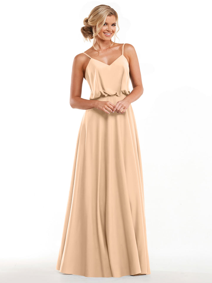 A woman stands and smiles, wearing Avery Austin&
